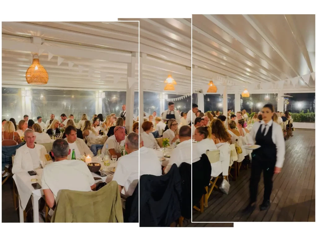 sala di un ristorante con delle persone vestite di bianco che mangiano durante il Ichi Party 25 anni.